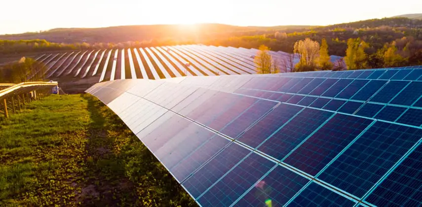Solar energy asset valuation – solar farm at sunset representing Lacima’s modelling support for renewable portfolios Solar farm at sunset representing renewable asset valuation and energy risk modelling