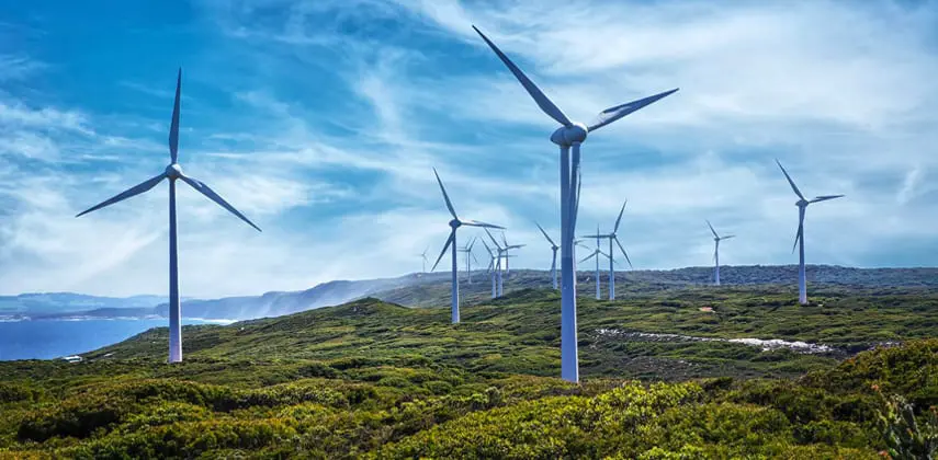 Wind generation risk modelling and earnings-at-risk analytics for Australian renewables portfolio Wind farm at sunset representing renewable energy risk analytics and earnings-at-risk modelling for Australian generation portfolios