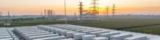 Image of a battery farm connected to the energy grid, representing the management and optimisation of operation, value, and risk of battery storage assets